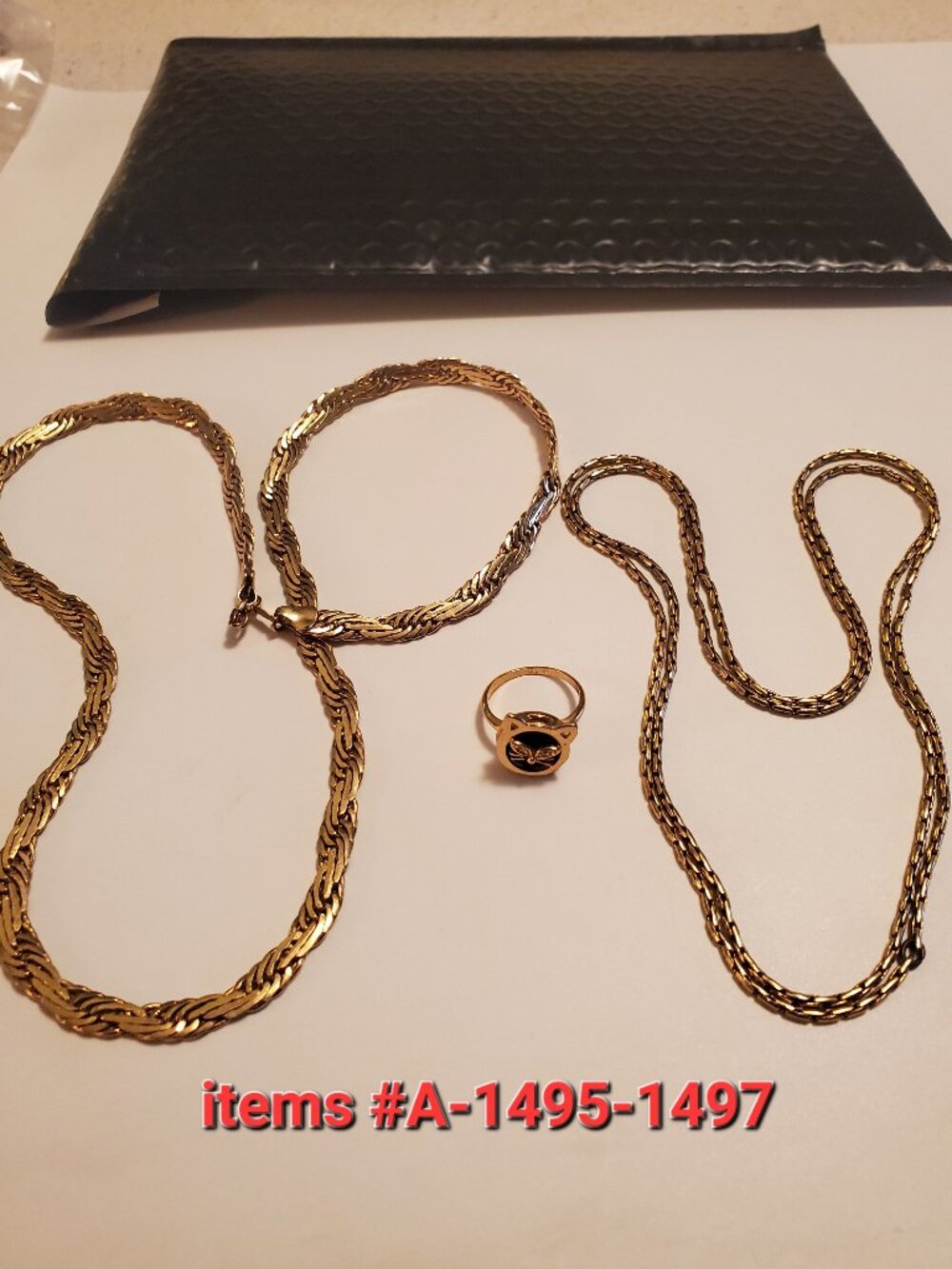 2 Gold Necklaces & 1 Gold Ring, item # A 1495-1497,. wt . 54 grams.